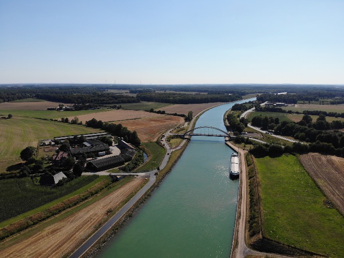 a river with a bridge and buildings