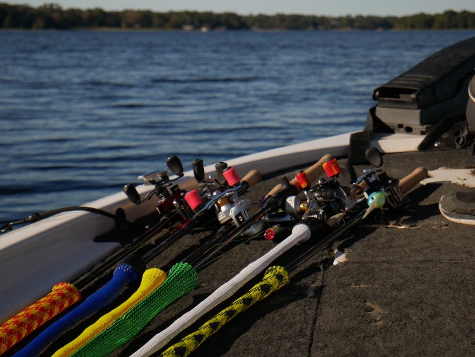 a row of fishing rods sitting on top of a boat
